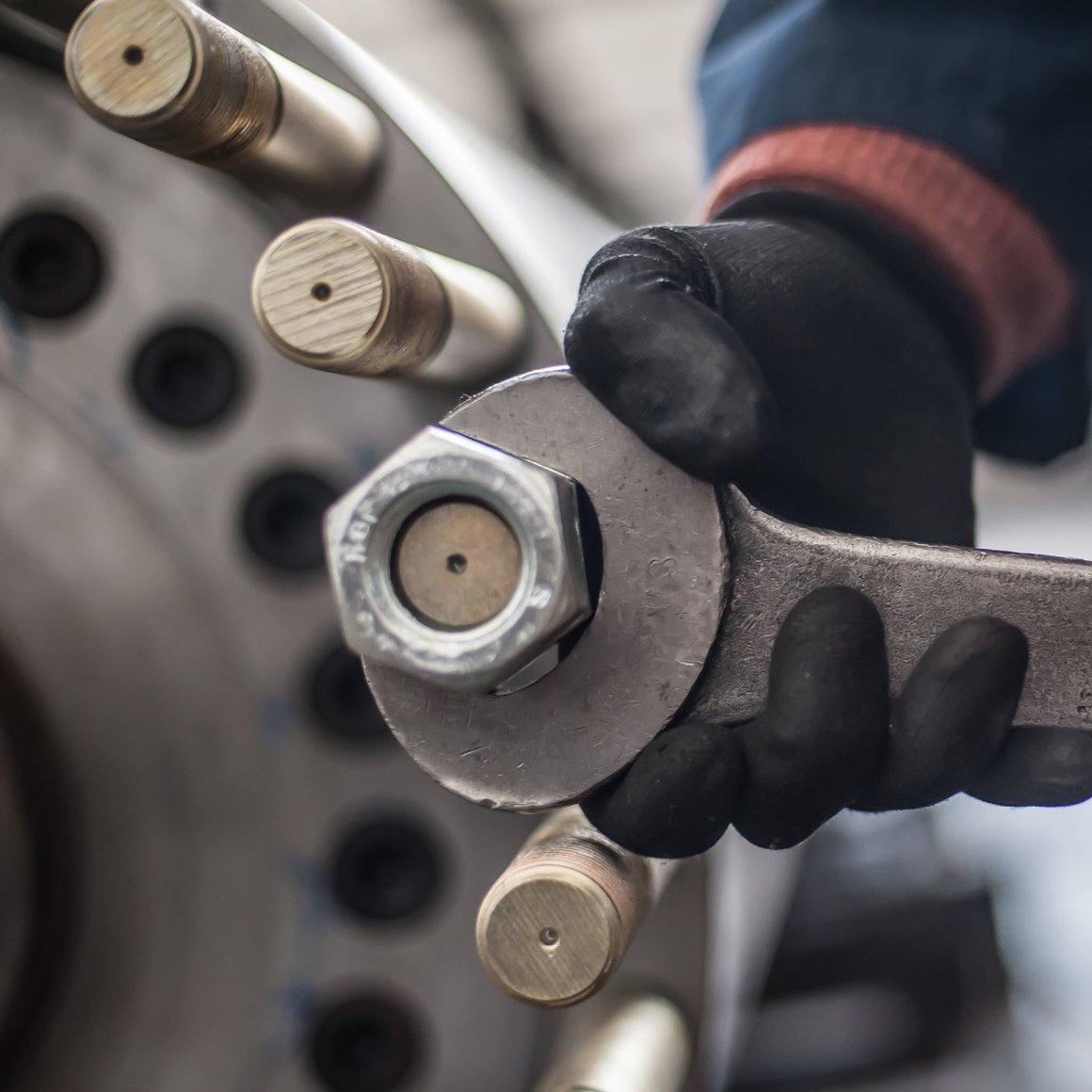 close up image of a hand with a tool wrench