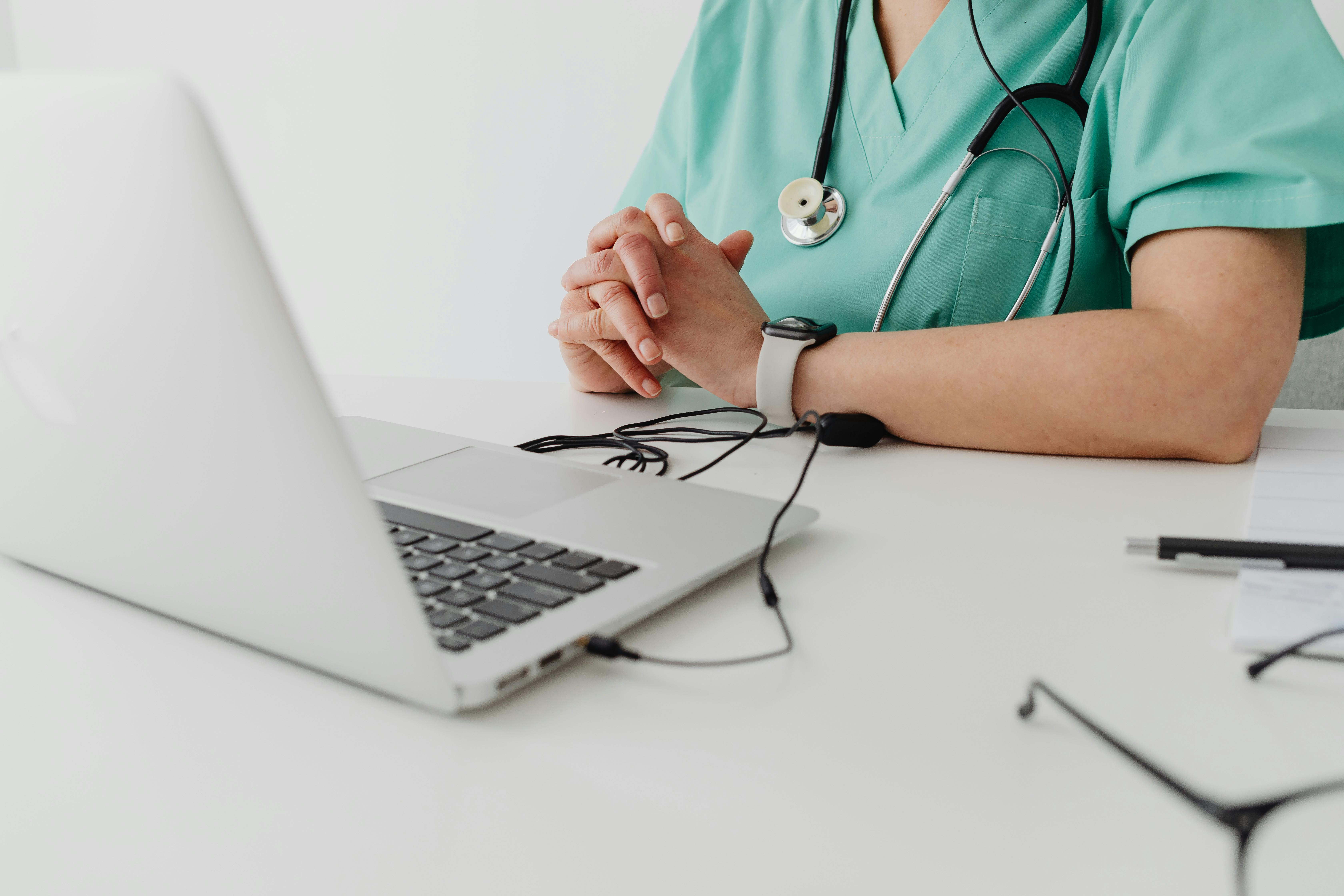 An image of a doctor in front of her laptop 